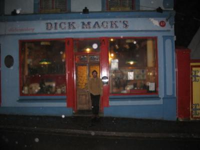 Con outside of Dick Mack's in the rain 